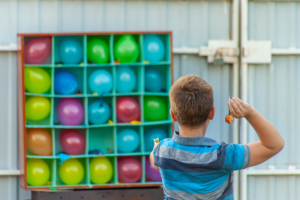 A kid playing carnival Balloon-Pop in Wilmington, DE.
