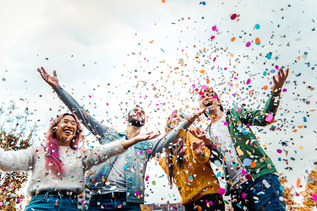 College event with students celebrating and throwing confetti. Host the best college events with diverse rental options in Wilmington, DE.