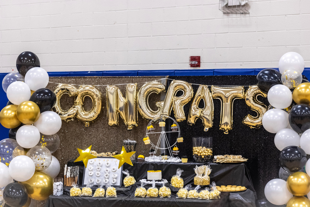 Graduation party setup with 'Congrats' banner, balloons, and a decorated table. Celebrate graduation milestones with exciting party rentals in Wilmington, DE.