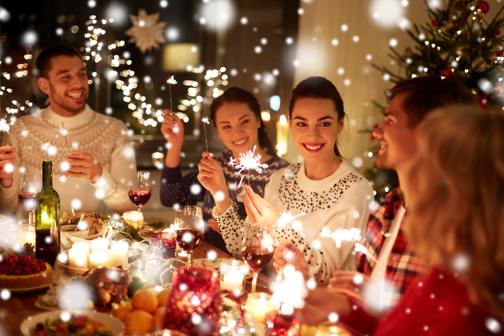Group of friends celebrating a holiday party with festive decorations and lights. Add festive cheer to your holiday gatherings with party rentals in Wilmington, DE.