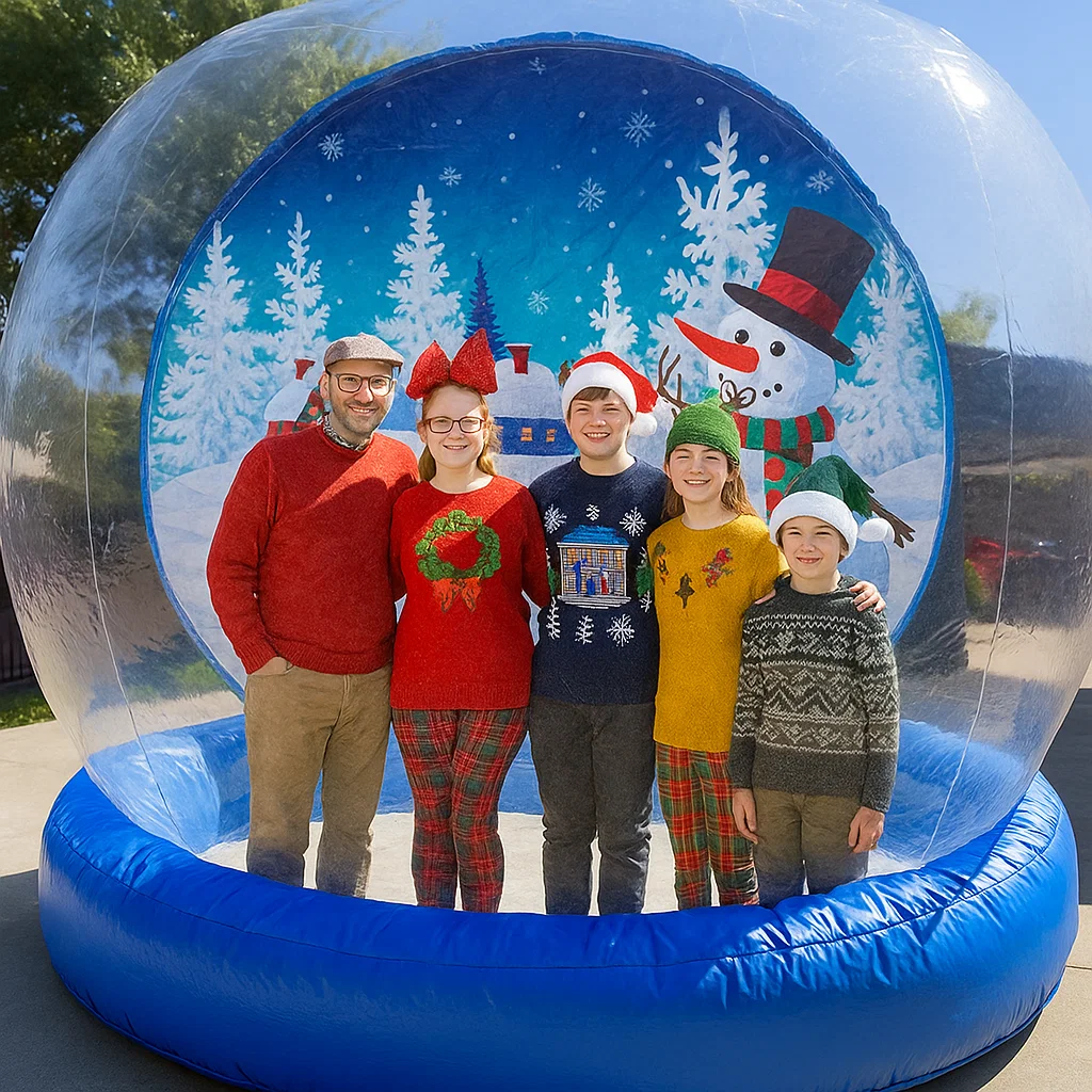 giant inflatable snow globe rental attendant guiding entry at HOA holiday party