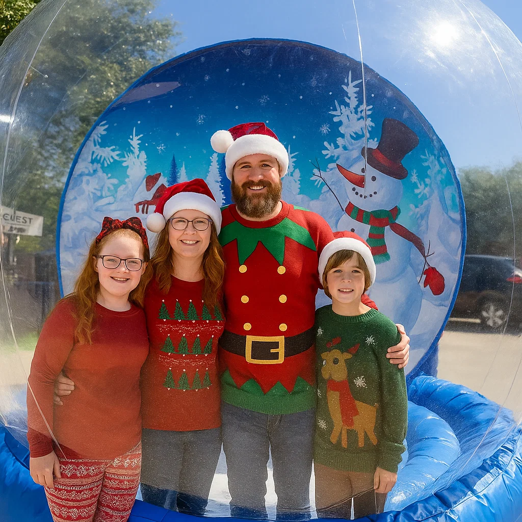 giant inflatable snow globe rental guests posing for photos at HOA holiday party by Party Pros East Coast