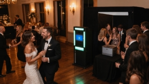 Guests using a large tent photo booth at a Blue Bell wedding reception