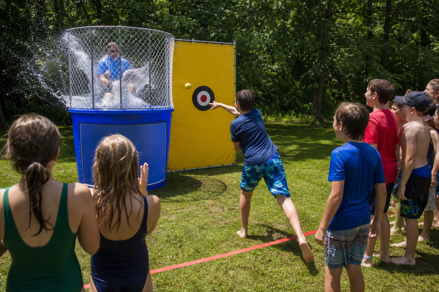 Camper throwing at a dunk tank during a Blue Bell PA water day
