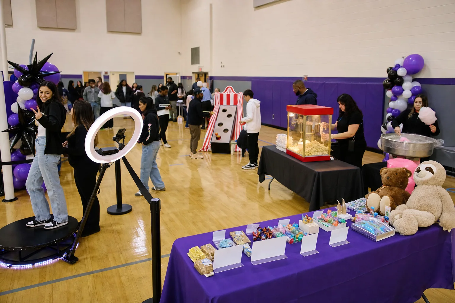 Fundraiser guests using a 360 photo booth, carnival games, popcorn, and cotton candy rentals in Philadelphia