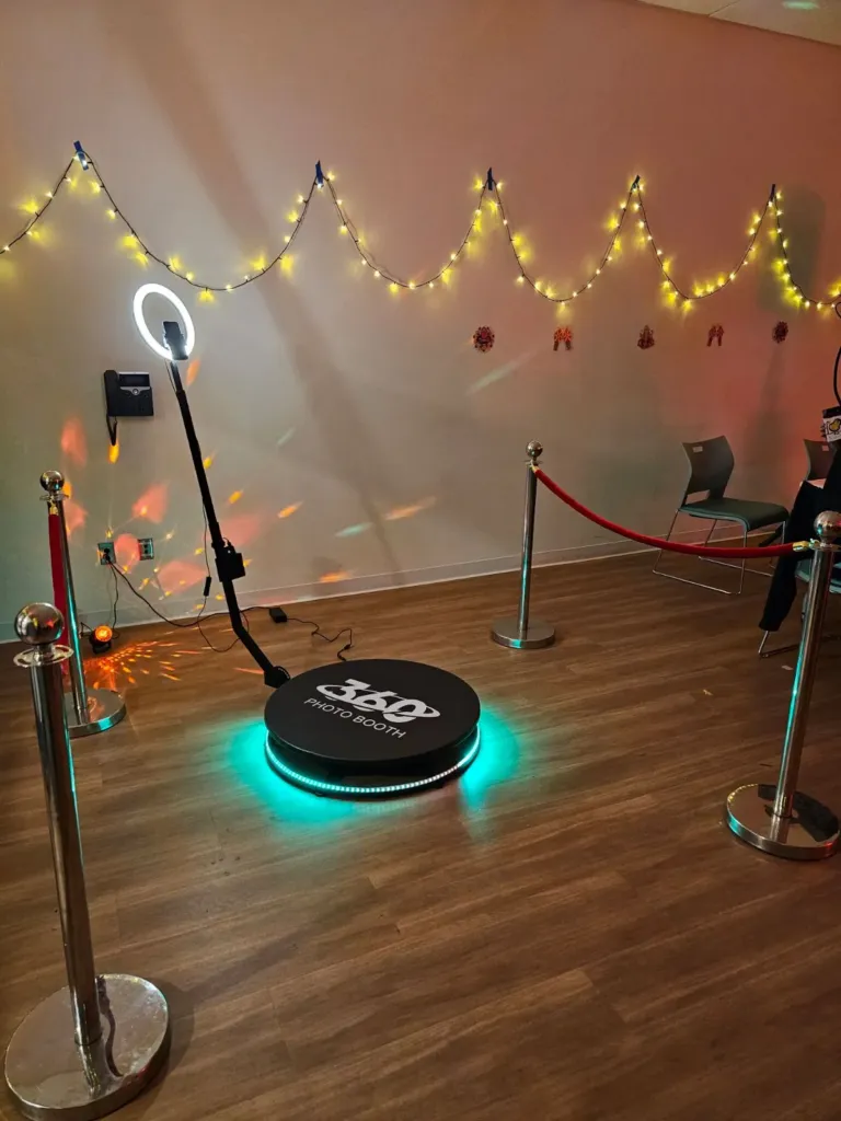 360 video photo booth platform with a ring light and stanchions set up in an event room