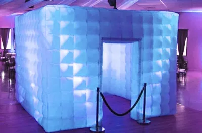 Inflatable LED photo booth lit up at an evening party by Party Pros East Coast
