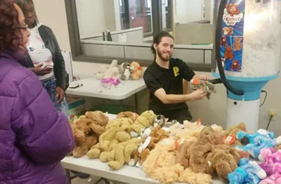 Guests building stuffed animals at a stuff a plush table