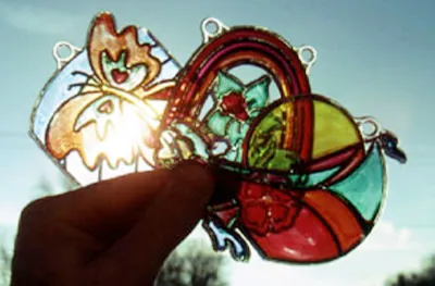 Hand-painted sun catchers held up to the light